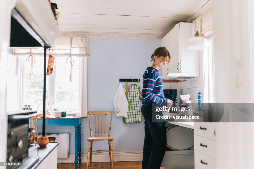 Young woman making morning coffee