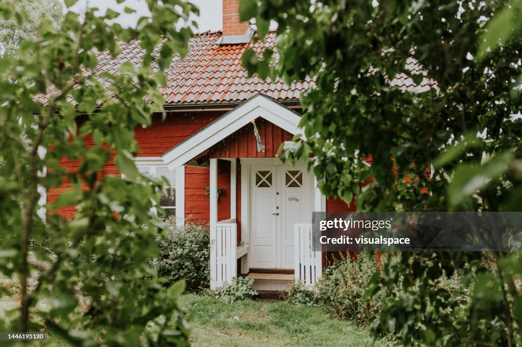 Red traditional nordic summer cottage