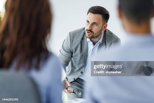 displeased ceo arguing with his colleagues on a presentation in the office. - distressed stock market people stock pictures, royalty-free photos & images