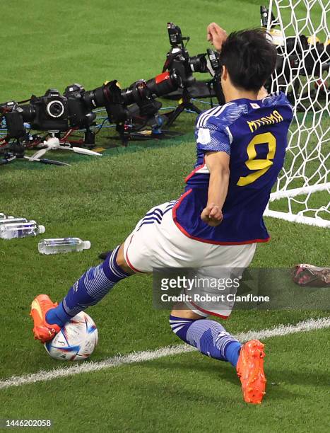 Kaoru Mitoma of Japan keeps the ball in play and passes the ball to Ao Tanaka of Japan to score the team's second goal during the FIFA World Cup...