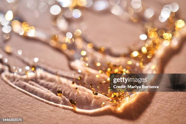 a drop of serum with golden particles, texture. - winter skin stock pictures, royalty-free photos & images