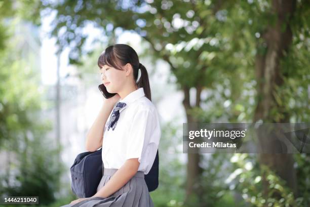 junior high school student making a phone call - female high school student stock pictures, royalty-free photos & images
