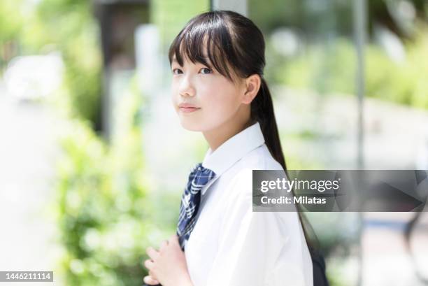 junior high school students waiting for the bus - female high school student stock pictures, royalty-free photos & images