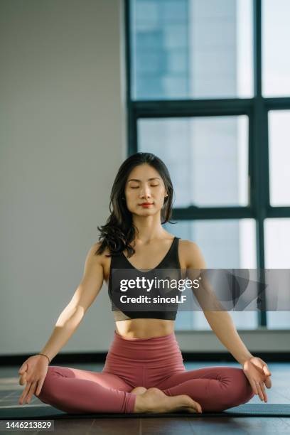 young asian yoga instructor, practicing yoga in the morning - pranayama stock pictures, royalty-free photos & images