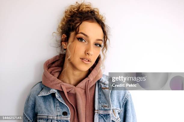 portrait of a young adult woman against a white background - jacket stock pictures, royalty-free photos & images