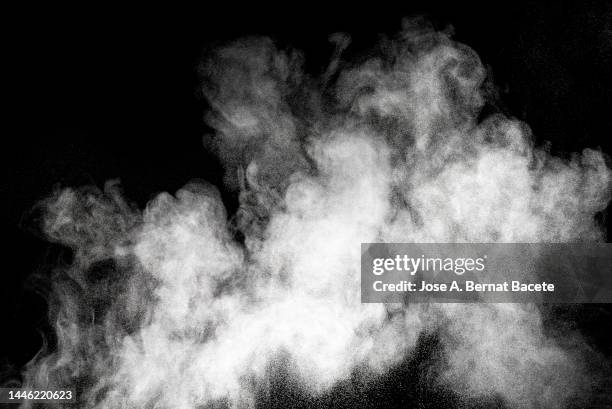 shock wave from an explosion of dust and smoke on a black background. - fumée photos et images de collection