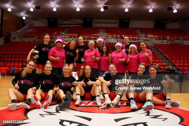 Share the Dignity Representatives take a group photo with the Perth Lynx during the round 4 WNBL match between Perth Lynx and Melbourne Boomers at...