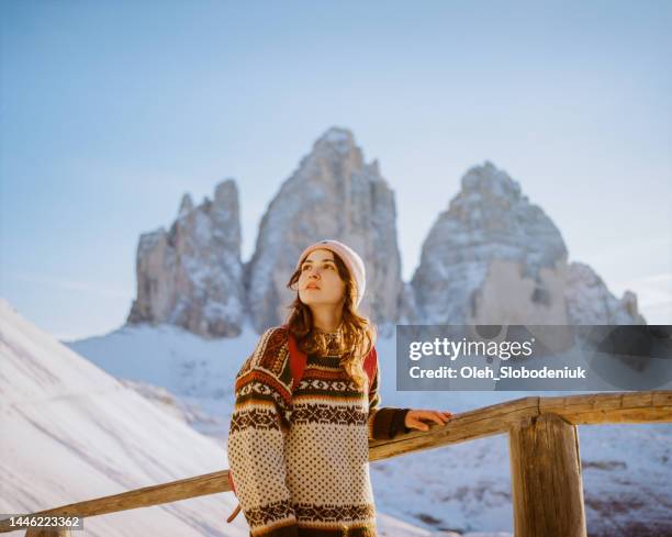 woman hiking  on the background of tre cime di lavaredo in winter. camera film - winter wonder land stockfoto's en -beelden