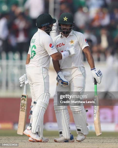 Abdullah Shafique of Pakistan congratulates Imam-Ul-Haq of Pakistan on his half century during the First Test Match between Pakistan and England at...