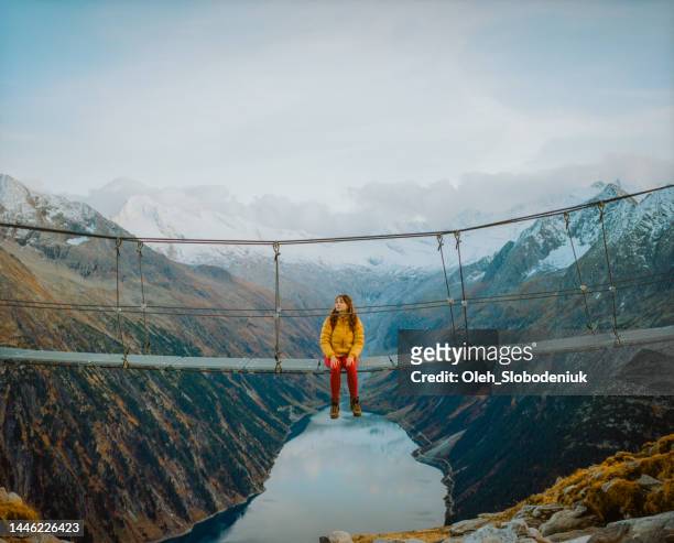 woman on the bridge on the background of lake in austrian alps - styrka stock pictures, royalty-free photos & images