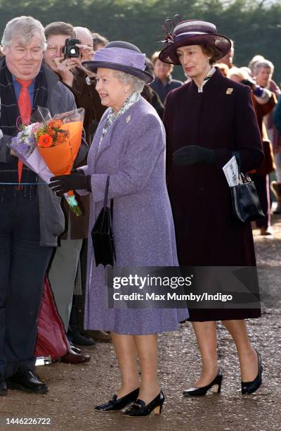 Queen Elizabeth II, accompanied by her lady-in-waiting Lady Susan Hussey, meets members of the public during a walkabout after attending Sunday...