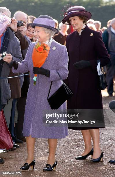 Queen Elizabeth II, accompanied by her lady-in-waiting Lady Susan Hussey, meets members of the public during a walkabout after attending Sunday...