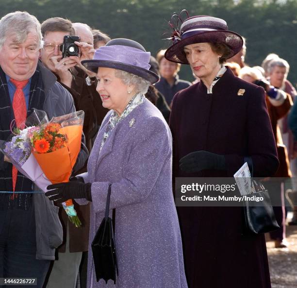 Queen Elizabeth II, accompanied by her lady-in-waiting Lady Susan Hussey, meets members of the public during a walkabout after attending Sunday...