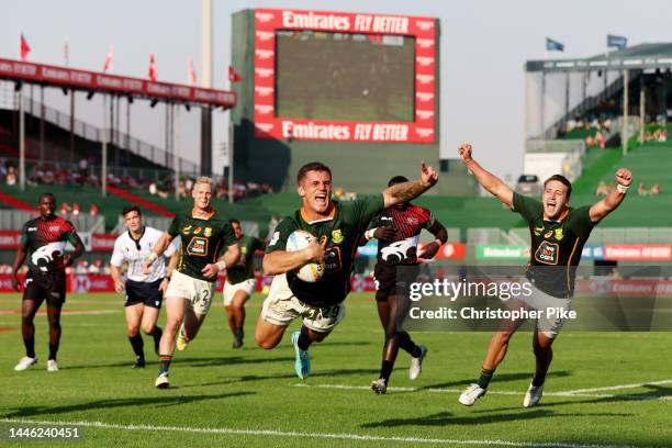 Ricardo Duarttee of South Africa celebrates scoring a try with teammate James Murphy during the match between South Africa and Kenya on day one of...