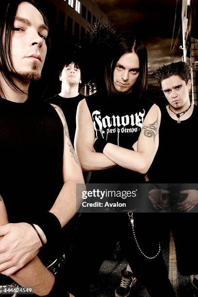 Portrait of British rock band Bullet For My Valentine pictured in an urban landscape at night with singer Matt Tuck raising his fist. The band are ....