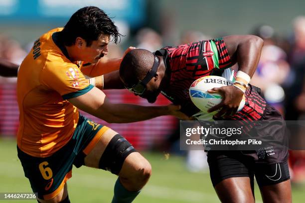 Willy Ambaka of Kenya evades the tackle of Tim Clements of Australia during the match between Australia and Kenya on day one of the HSBC World Rugby...