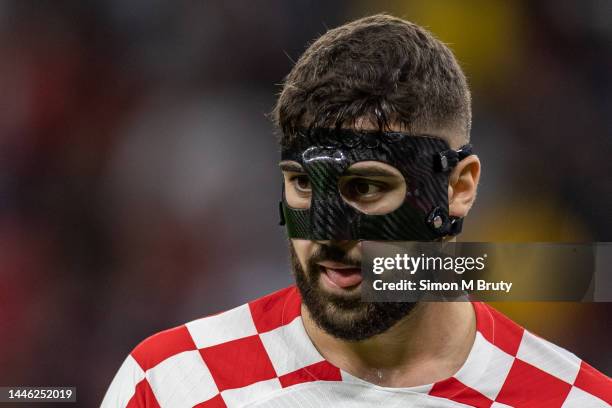 Josko Gvardiol of Croatia wearing a protective mask during the FIFA World Cup Qatar 2022 Group F match between Croatia and Belgium at Ahmad bin Ali...