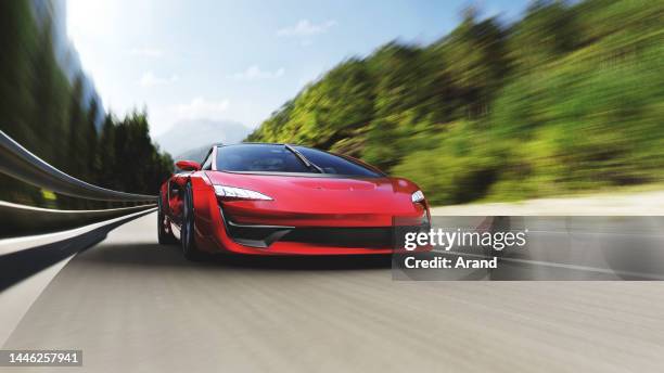 auto sportiva rossa che guida su una strada di montagna - ferrari foto e immagini stock