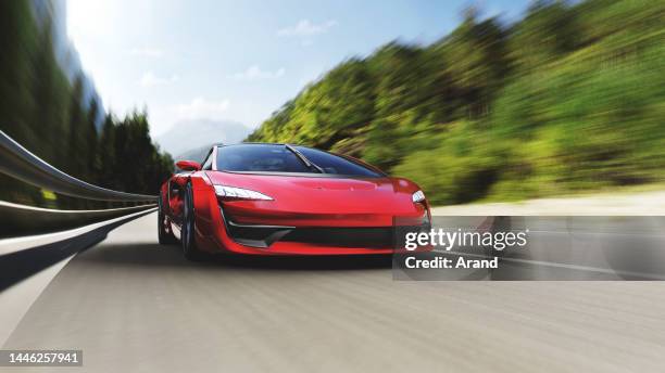 red sports car driving on a mountain road - red porsche stock pictures, royalty-free photos & images