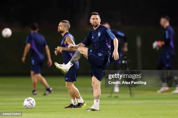 Lionel Messi of Argentina stretches during the Argentina training session on match day -1 ahead of their round of sixteen match against Australia as...