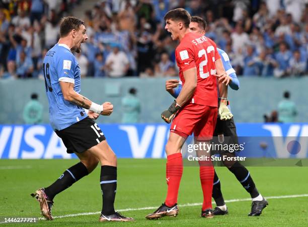 Sergio Rochet of Uruguay is congratulated by his teammate Sebastian Coates during the FIFA World Cup Qatar 2022 Group H match between Ghana and...