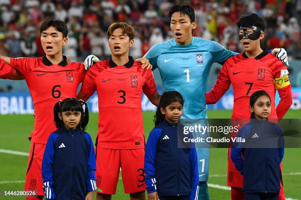 Heungmin Son of Korea Republic sings the national anthem with teammates prior to the FIFA World Cup Qatar 2022 Group H match between Korea Republic...