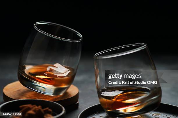 the glass of whisky on the table with dark background - cognac fotografías e imágenes de stock