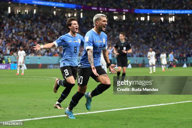 Giorgian de Arrascaeta of Uruguay celebrates scoring the team's second goal with teammate Facundo Pellistri during the FIFA World Cup Qatar 2022...