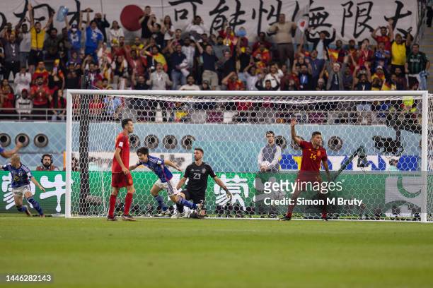 Rodri of Spain reacts to the referee as Ao Tanaka of Japan celebrates scoring the winning goal during the FIFA World Cup Qatar 2022 Group E match...