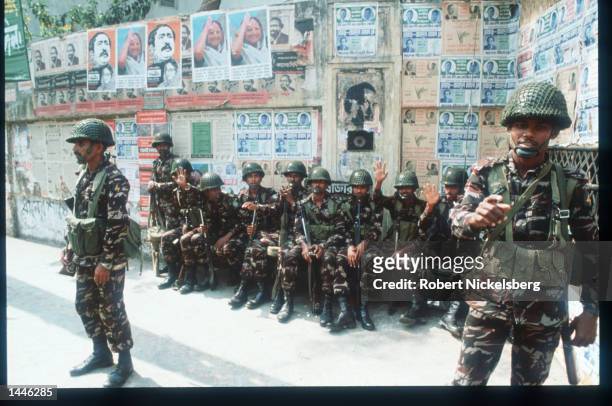 Soldiers stand in the street February 26, 1991 in Dhaka, Bangladesh. The first parliamentary elections will be held tomorrow after ten years of...