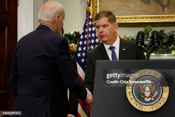 President Joe Biden shakes hands with Labor Secretary Marty Walsh after signing bipartisan legislation averting a rail workers strike in the...