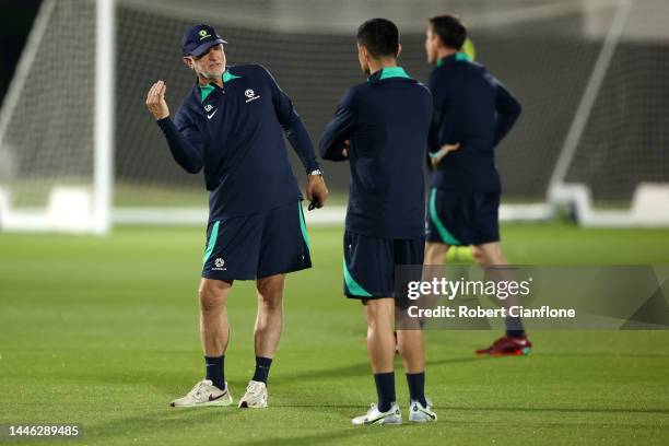 Graham Arnold, Head Coach of Australia, speaks with Tim Cahill, Coach of Australia during Australia Training Session ahead of their Round of Sixteen...