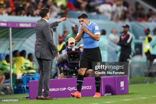 Diego Alonso, Head Coach of Uruguay, reacts with Luis Suarez after a substitution during the FIFA World Cup Qatar 2022 Group H match between Ghana...