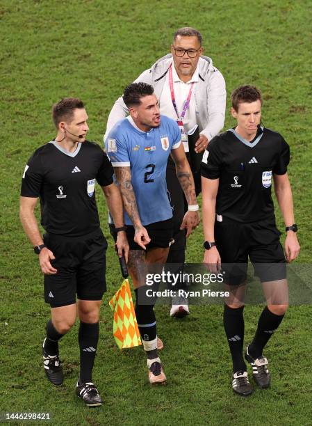 Jose Maria Gimenez of Uruguay argues with referee Daniel Siebert during the FIFA World Cup Qatar 2022 Group H match between Ghana and Uruguay at Al...