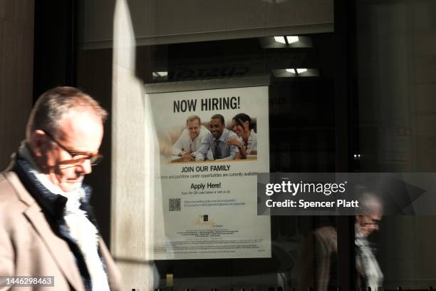 Now hiring' sign is displayed in a window of a store in Manhattan on December 02, 2022 in New York City. The Labor Department reported Friday that...