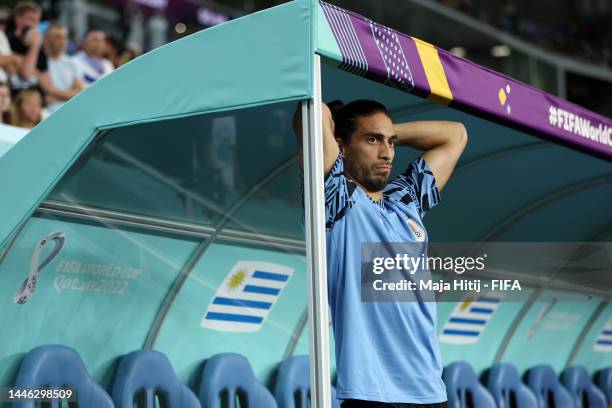 Martin Caceres of Uruguay shows dejection after the team fails to qualify for the knockout stage despite their 2-0 victory in the FIFA World Cup...