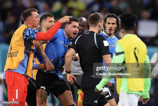 Uruguay players argue with referee Daniel Siebert after the FIFA World Cup Qatar 2022 Group H match between Ghana and Uruguay at Al Janoub Stadium on...