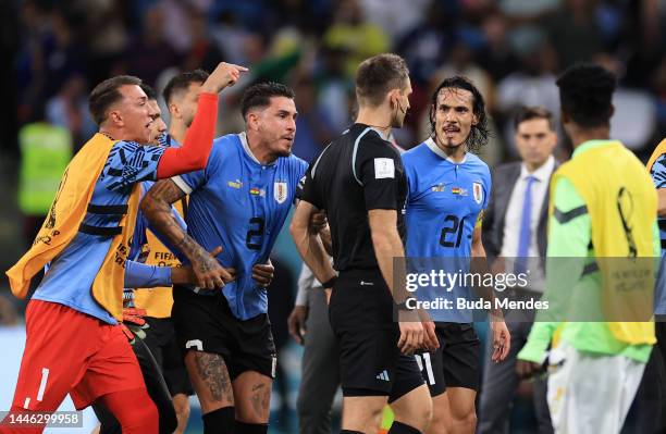 Uruguay players argue with referee Daniel Siebert after the FIFA World Cup Qatar 2022 Group H match between Ghana and Uruguay at Al Janoub Stadium on...