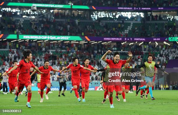 Korea Republic players celebrate after the team's qualification to the knockout stages during the FIFA World Cup Qatar 2022 Group H match between...