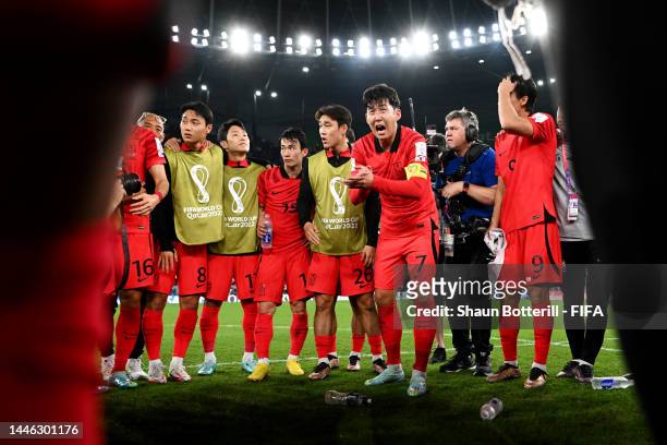 Heungmin Son of Korea Republic speaks to his teammates after the 2-1 win during the FIFA World Cup Qatar 2022 Group H match between Korea Republic...