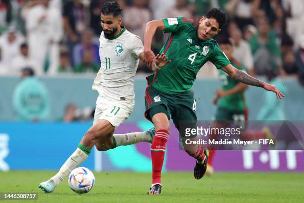 Saleh Al-Shehri of Saudi Arabia and Edson Alvarez of Mexico compete for the ball during the FIFA World Cup Qatar 2022 Group C match between Saudi...