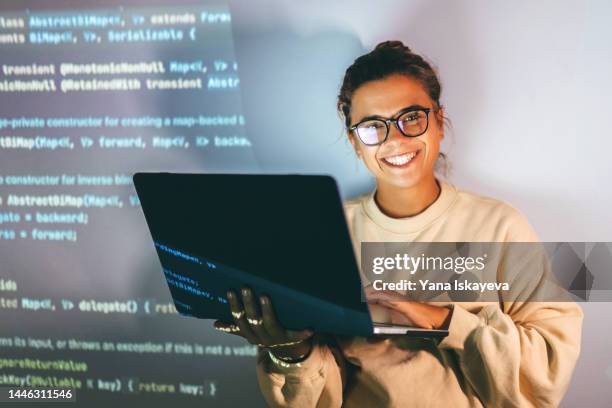 young woman, ceo and programmer, in smart glasses working with laptop at night - nerd woman stock-fotos und bilder