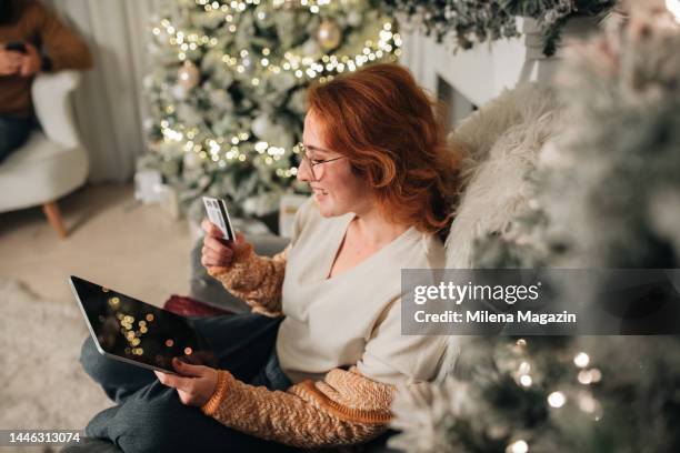 woman using digital tablet for christmas online shopping - christmas background no people stock pictures, royalty-free photos & images