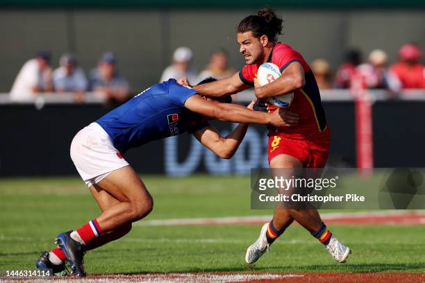 Juan Martinez of Spain evades a tackle during the match between France and Spain on day one of the HSBC World Rugby Sevens Series - Dubai at The...