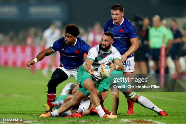 Mark Roche of Ireland passes the ball during the match between Ireland and France on day one of the HSBC World Rugby Sevens Series - Dubai at The...