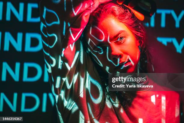 crimson red technological concept with a person lit with neon cyan projection - arts culture and entertainment photos fotografías e imágenes de stock