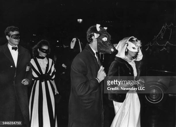 Partygoers arrive at the Black and White Ball, a masquerade party held on November 28, 1966 at the Plaza Hotel in New York City, hosted by author...