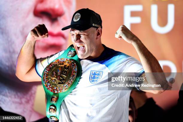 Tyson Fury reacts wearing an England football shirt during the Tyson Fury v Derek Chisora: Weigh-In at Business Design Centre on December 02, 2022 in...