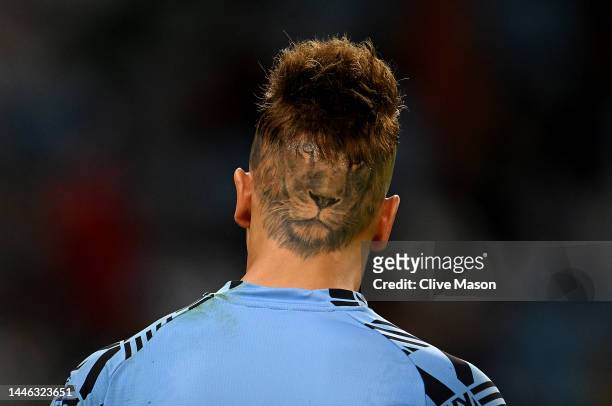 Sebastian Sosa of Uruguay shows his lion tattoo whilst he warms up prior to the during the FIFA World Cup Qatar 2022 Group H match between Ghana and...