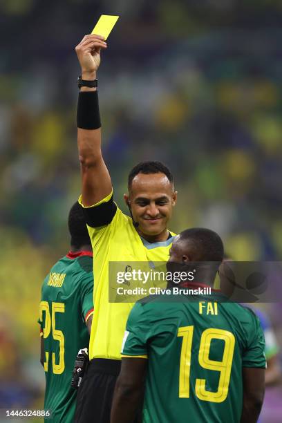 Referee Ismail Elfath shows a yellow card to Collins Fai of Cameroon during the FIFA World Cup Qatar 2022 Group G match between Cameroon and Brazil...